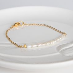 Delicate pearl bracelet - pearl bracelet for bride - Pearl bead bracelet - Delicate Ivory bracelet - Bracelet femme - Delicate Beaded Bracelet, Simple Pearl Bracelet, Wedding Jewelry, Layering Bracelet, Dainty Bracelet Dainty & Classic Bracelet from Magoo. It's the perfect bracelet for Layering, Stacking Bracelet with your other favourite pieces or just wear it alone. A delicate golden chain & beads bracelet with small rice shaped freshwater pearl beads on a Goldfield chain bracelet. Your item w Minimalist White Beaded Bracelets For Wedding, White Minimalist Bracelets For Anniversary, Minimalist White Bracelets For Anniversary, Dainty White Beaded Bracelet For Anniversary, White Gold Jubilee Bracelet For Wedding, White Beaded Bracelet With Pearl Chain For Wedding, Anniversary Beaded Bracelets With Pearl Chain, White Gold Bracelet With Round Beads For Wedding, Pearl White Beaded Bracelets With Pearl Chain For Anniversary