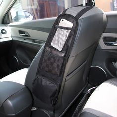 the back seat of a car with a cell phone in it's pocket and an arm rest