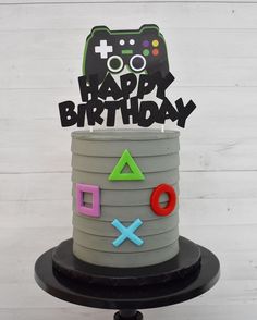 a birthday cake with an image of a video game controller on top