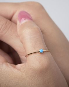 "This Turquoise Ring is the perfect addition to your minimalist jewelry collection. Our solitaire ring is meant to be classic enough for everyday wear or to give as a bridesmaid gift. This stacking ring will deﬁnitely be a favorite of yours! ** PLEASE NOTE: The model is wearing multiple rings. This listing is for Turquoise Ring ** At LunaiJewelry, we take pride in the details and love we pour into everything we make. We know you'll find something lovely for yourself or to give as a gift to someo Elegant 14k Gold Turquoise Birthstone Ring, Minimalist Turquoise Jewelry For Anniversary, Turquoise Minimalist Jewelry For Anniversary, Dainty Adjustable Turquoise Promise Ring, Turquoise Round Band Ring For Anniversary, Elegant Turquoise Ring For Anniversary With Round Band, Elegant 14k Gold Turquoise Ring For Promise, Elegant Turquoise Ring With Round Band For Anniversary, Elegant 14k Gold Turquoise Promise Ring