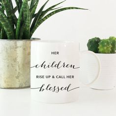 two mugs with plants in them on a table