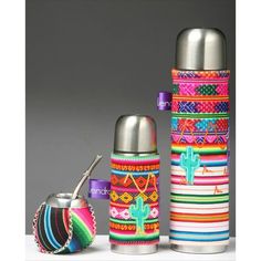 thermos are lined up next to each other with different colors and designs on them