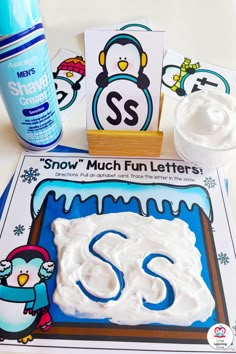 a penguin themed letter s craft is on the table next to it's contents