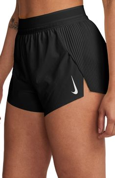 These mid-rise running shorts offer moisture-wicking comfort and side slits to keep you moving with comfort and confidence. 3" inseam; 23" leg opening; 12 1/2" front rise; 15" back rise (size Medium) Elastic waist with internal drawcord Three internal drop-in pockets Dri-FIT moisture-wicking technology Stretch lining 86% polyester, 14% spandex Machine wash, tumble dry Imported Nike Air Swift Shorts, Running Attire Women, Things To Buy For Summer, Running Essentials For Women, Girly Workout Outfits, Cross Country Outfits, Spandex Shorts Outfit, Tracksmith Running, Nike Clothes Women