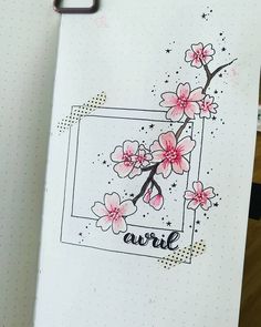 an open notebook with pink flowers on it