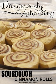 there is a plate full of cinnamon rolls on the table with text that reads, dangerously adulting sourdough cinnamon rolls