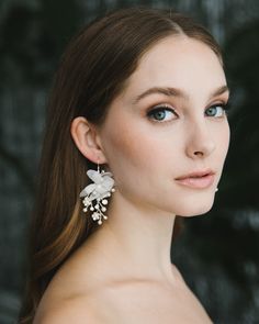 "TULLE FLOWER DANGLE EARRINGS (JE-4433) Classic bridal elements meet modern design with our Tulle Flower Dangle Earrings. Crafted with tulle petals surrounding hand wired vines of pearls & crystals, these earrings are lightweight for comfortable all day wear. DETAILS * Tulle petals, off white pearls, metal flowers & crystals * Measures 1.5 x 2.25\"   * Hypoallergenic, lead-free & nickel-free  * Style #4433 SHOP MORE STYLES https://www.etsy.com/shop/darethcolburndesigns NEED MORE HELP? Happy to o Flower Drop Earrings For Wedding, Wedding Flower Drop Earrings For Pierced Ears, Wedding Flower Drop Earrings, Silver Flower Pearl Earrings For Wedding, Delicate Pearl Earrings With Flower Charm For Wedding, Dangle Flower Earrings For Wedding, Flower Cluster Earrings For Wedding, Flower Shaped Chandelier Earrings For Wedding, White Dangle Earrings For Brides