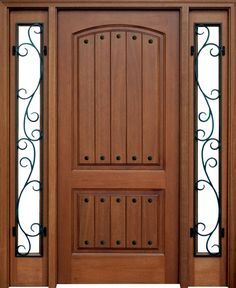 a wooden door with wrought iron work on the top and side panels, along with glass