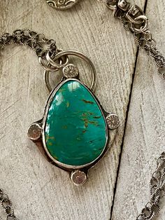 Patagonia turquoise from Arizona is this deep color of green in a teardrop shape set in sterling silver. It hangs from a textured sterling silver oxidized chain with a small fine silver charm finishing it off with sterling silver findings. The chain is 18 inches in length with the pendant adding another 1 3/4 inches.  For more artisan jewelry you can re enter my shop here:  https://www.etsy.com/shop/DianesAddiction?ref=si_shop Thanks for visiting my shop. Southwestern Turquoise Necklace With Large Green Pendant, Southwestern Green Turquoise Necklace With Large Pendant, Green Turquoise Necklace With Large Southwestern Pendant, Turquoise Teardrop Pendant Jewelry, Turquoise Teardrop Gemstone Pendant Jewelry, Handmade Turquoise Drop Jewelry, Sterling Silver Turquoise Teardrop Necklace, Bohemian Green Turquoise Necklace With Large Pendant, Blue Turquoise Necklace With Large Teardrop Stone