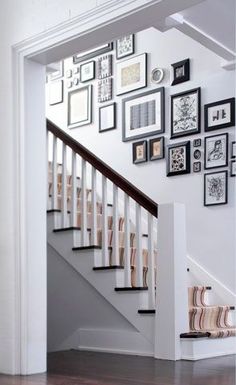 an image of a staircase with pictures on the wall