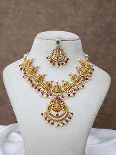 This stunning jewelry set includes a round necklace with earrings .  Perfect for all your special occasions, this necklace is crafted in high-quality metals and embellished with CZ stones and pearls . Features: - Round necklace - Crafted in high-quality metals - Embellished with CZ stones and pearls Temple Jewelry Sets For Celebration, Temple Jewelry For Puja With Jeweled Details, Temple Jewelry Jeweled For Puja, Festive Jeweled Jewelry Sets, Round Jewelry Sets With Peacock Design, Peacock Design Jewelry Sets As Gift, Gift Jewelry Sets With Peacock Design, Jeweled Chandbali Temple Necklace As A Gift, Round Pearl Necklace For Diwali Celebration