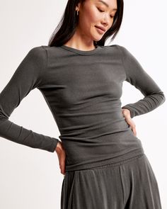 Slim-fitting long-sleeve tee in our soft cozy lounge knit fabric and tuckable length, featuring a crew neckline and all-over texture detail. Cozy Lounge, Women's Sleepwear, New Arrival Dress, Sleepwear Women, Swimwear Accessories, American Apparel, Crew Neckline, Abercrombie Fitch, Dark Gray