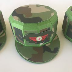 three hats made to look like the green ranger's helmet, one with red wings on it