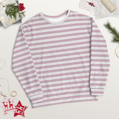 Treat yourself or a loved one to the ultimate cozy wardrobe staple! This pink striped shirt is made from a soft and durable material that feels great to wear. Plus, the inside's brushed fleece gives an extra comfy feel.  Whether you're running errands or having a relaxing night in, this crewneck sweatshirt is the perfect gift for any woman.  Get your hands on it now and experience true comfort and style! ⚠️ PLEASE NOTE: ⚠️ 🎅🏼 To ensure that your package has the best possible chance of arriving in time for 🎄Christmas: ⭐️ For deliveries to the United States, please order before December 11th; ⭐️ For deliveries to Europe, please order before December 14th. ✨ SPECIFICATIONS ✨ * 95% recycled polyester, 5% spandex * Fabric weight (may vary by 5 9.08 oz./yd.² (308 g/m²) * Soft cotton-feel fabr Striped Long Sleeve Sweatshirt For Winter, Striped Long Sleeve Sweater For Loungewear, White Long Sleeve Sweater With Horizontal Stripes, Casual Long Sleeve Striped Sweater, Striped Sweatshirt For Fall Loungewear, Winter Sweatshirt With Contrast Stripes, Striped Sweatshirt For Loungewear In Fall, Winter Contrast Stripes Long Sleeve Sweatshirt, Winter Striped Relaxed Fit Sweatshirt