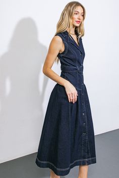 This exquisite denim midi dress boasts a lapel collar, sleeveless design, button front closure, self-tie belt, and a flattering drop waist.Details:Self : 70% Cotton 28% Polyester 2% SpandexSize & Fit- Model is 5`10" And Wearing Size Small- Measurements Taken From Size Small- Approx. Length: 50" Denim Midi Dress, Drop Waist Dress, Flying Tomato, Belt Tying, Dark Indigo, Waist Dress, Drop Waist, Lapel Collar, Tie Belt