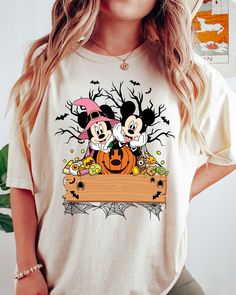 Retro Mickey Minnie Halloween Shirt, Mickey Minnie Pumpkin T-Shirt, Spooky Season Gifts, Cute Halloween Shirts, Trick Or Treat Sweatshirt -UNISEX T-SHIRTS - Women typically wear one size down for a fitted look. -The Models in the pictures are wearing 2 sizes up, Please order 2 sizes up for an oversized look DETAILS AND FABRIC: * Comfort Colors 1717 * 100% ring-spun cotton How you order: Select your size and the color that you want from the drop down bar, add to cart, and check out.  How to order Halloween Mickey Mouse T-shirt For Disney Fans, Halloween Mickey Mouse Short Sleeve T-shirt, Disney Halloween Cotton T-shirt, Disney Halloween Character Print T-shirt, Disney Halloween T-shirt With Character Print, Halloween Mickey Mouse Crew Neck Top, Fall Mickey Mouse Crew Neck T-shirt, Disney Crew Neck Top For Halloween, Minnie Shirt