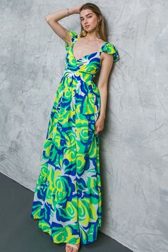 This gorgeous floral-printed woven maxi dress features a flattering V neckline, a waist yoke, tiered skirt, smocked back for comfort and flexibility, and high-quality woven fabric. Its captivating print and romantic bohemian vibe is perfect for any event, making you look and feel stunning. Enjoy the beauty of nature and the comfort of this dress. Details Self: 100% Polyester Lining: 100% Polyester Size & Fit - Model is 5`8 " And Wearing Size Small - Measurements Taken From Size Small - Approx. L Green V-neck Maxi Dress With Smocked Back, Green Maxi Dress With Smocked Bodice For Garden Party, Green Maxi Dress With Smocked Bodice For Spring, Green Smocked Bodice Tiered Skirt Dress, Green Tiered Dress With Smocked Bodice, Green Fitted Tiered Skirt Maxi Dress, Green Smocked Bodice Maxi Dress For Vacation, Green Tiered Skirt Maxi Dress For Garden Party, Green Maxi Dress For Garden Party