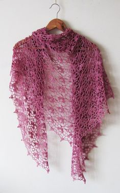 a pink shawl hanging on a white wall