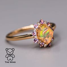 Mexican Fire Opal Amethyst Diamond Engagement Halo Ring 18K Yellow Gold. Free Domestic USPS First Class Shipping! Free One Year Limited Warranty! Free Gift Bag or Box with every order! Opal—the queen of gemstones, is one of the most beautiful and rarest gemstones on earth. Every piece of opals has its colors and patterns, which is perfect for designers to create unique engagement rings for someone extra special. Our jewelry uses 100% Natural & Ethical opal stones (NO synthetics or imitations). - Opal And Diamond Wedding Ring, Amethyst And Opal Engagement Ring, Fire Opal Wedding Ring, Opal Sapphire Ring, Whimsy Rings, Gold Opal Rings, Rarest Gemstones, Fire Opal Engagement Ring, Opal Promise Ring