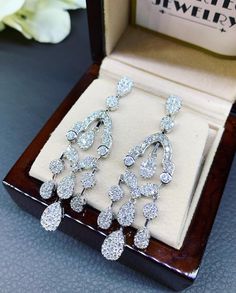 HANDCRAFTED TO PERFECTION! SPECIAL AND LOVELY FLORAL DESIGN, ILLUSION SETTING (APPEARS TO BE LIKE A 0.5-1.0 CARAT BRILLIANT PEAR Diamonds). With over 128 pieces of UNTREATED AND GENUINE F/VS QUALITY SPARKLING DIAMONDS! Perfect for every event! SET IN 18K SOLID WHITE GOLD HANDCRAFTED, CHANDELIER EARRINGS! SUGGESTED RETAIL VALUE: $11,000 DIAMONDS: 254 ROUND BRILLIANT, FULL CUT with excellent firing diamonds, weighting at 3.50 carats. ALL NATURAL, UNTREATED DIAMONDS. ALL DIAMONDS HAVE NO VISIBLE IN Luxury Pear-shaped Chandelier Earrings For Formal Events, Luxury Diamond Accented Drop Chandelier Earrings, Luxury Teardrop Chandelier Earrings With Diamond Accents, Luxury Diamond Cut Diamond White Chandelier Earrings, Luxury Platinum Dangle Diamond Earrings, Luxury Diamond Cut Chandelier Earrings In Diamond White, Formal Diamond White Chandelier Earrings With Brilliant Cut, Luxury Diamond Chandelier Earrings With Diamond Cut, Elegant White Gold Pear-shaped Chandelier Earrings