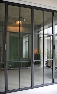 an empty room with sliding glass doors leading to the outside