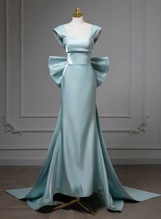 Lustrous in its presentation, this prom dress embodies a blend of classic charm and contemporary chic. The cool mint color evokes the serenity of a tranquil sea, while the off-the-shoulder sleeves and prominent waist bow add a touch of youthful exuberance. Meticulously stitched, the dress hugs the body in all the right places before descending into a soft train, creating a silhouette that is as enchanting as it is flattering. This is a dress designed for the girl who wants to make a subtle yet stunning impact on her prom night. Bow Prom Dress, Purple Tulle, Strapless Prom Dress, Branding Inspo, Long Sleeve Prom, Haute Couture Dresses, Blue Mermaid, Pop Socket, Contemporary Chic