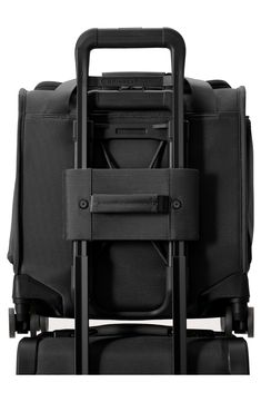 the back side of a black suitcase with wheels and straps on it's sides