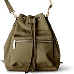 an olive green purse with zippers on the front and shoulder straps, attached to a white background