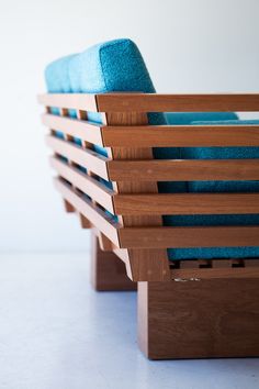 a wooden bench with blue cushions on it