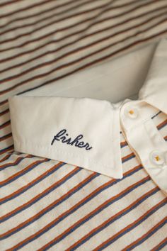 a close up of a shirt with the name peter written on it's collar