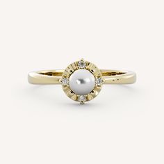 a pearl and diamond ring on a white background