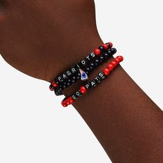 A whole new way to rep the team in style is here. Step up your fan fashion sense with this New England Patriots 3 Pack Beaded Friendship Bracelet. These matching friendship bracelets have an all-over team-colored design and team logo displays, which makes them the perfect way to show your support for the New England Patriots on gamedays and every day in between. Every bead bracelet design is the perfect addition to your outfit, whether you’re heading to the game, watching at home, or just hangin Casual Team-colored Beaded Bracelets For Sports Events, Casual Beaded Bracelets In Team Colors For Sports Events, Casual Multicolor Bracelets For Game Day, Casual Red Beaded Bracelet For Sports Events, Game Day Black Wristband With Letter Beads, Black Team Spirit Jewelry For Game Day, Casual Adjustable Wristband For Fan Merchandise, Black Team Spirit Adjustable Beaded Bracelets, Black Adjustable Beaded Bracelets Team Spirit Style