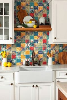 Colorful kitchen with mosaic tile backsplash, white cabinets, a farmhouse sink, and wooden cutting boards. Farmhouse Kitchen Design Ideas, Charming Farmhouse