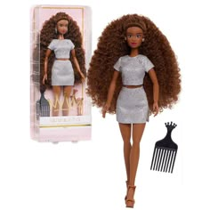 the doll is wearing a silver dress and has a hair comb in her left hand