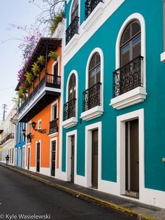 an empty street in front of colorful buildings