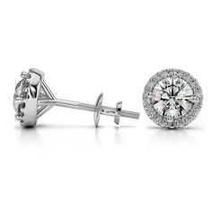 These beautiful diamond stud earrings feature two round cut diamonds in a white gold prong setting that are encircled in a halo of pave set diamonds. Each G color, VS2 clarity, Excellent cut center diamond weighs 0.36 carat, for a total diamond weight of 1 carat. Formal Round Cut Cluster Earrings With Diamond Cut, Formal Round Cut Diamond Cluster Earrings, Round Platinum Cluster Earrings With Diamond Cut, Platinum Cluster Earrings With Prong Setting For Formal Occasions, Platinum Cluster Earrings With Prong Setting For Formal Events, Formal Platinum Prong Set Cluster Earrings, Fine Jewelry Round Cluster Earrings With Vvs Clarity, Vvs Clarity Round Cluster Earrings Fine Jewelry, Diamond Cluster Earrings For Anniversary