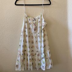 Off-White Floral Urban Outfitters Dress With Buttons, Size M, New With Tags White Summer Sundress For Day Out, White Cotton Sundress For Spring, White Cotton Mini Dress With Floral Print, White Floral Print Sundress For Vacation, Off White Mini Sundress For Vacation, White Smocked Sundress For Spring, Summer Style Off White Sundress For Brunch, White Floral Sundress Mini Dress, Casual Off White Summer Dress