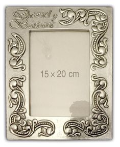 a metal frame with an ornate design on the front and bottom, is shown in silver