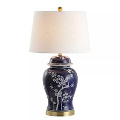 a blue and white table lamp with a gold base on an isolated white background,