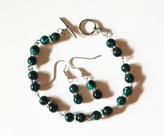 "Title: Black and green bead bracelet, green tiger eye beaded bracelet, dainty bead bracelet, dark green bracelet, green jewelry set, small bead bracelet, green and black bracelet, green bead earrings Description: This green jewelry set consists of small black and green bead earrings and a matching green tiger eye style small bead bracelet. The pieces may also be purchased individually. You can buy just the black and green chain bracelet, or just the green drop earrings. The tiger eye pattern on Green Tiger Eye, Small Bead Bracelet, Candle Dye, Green Beaded Bracelets, Tiger Eye Beads, Green Jewelry, Black Bracelets, Green Earrings, Green Bead