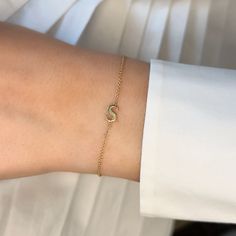 This bracelet showcases your chosen initial in a refined and delicate design. Its minimalist style makes it versatile for any occasion, whether you're dressing up for a special event or adding a personal touch to your everyday ensemble. Ideal as a thoughtful gift or a personal treat, it’s a timeless addition to any jewelry collection. Available in 14K Yellow Gold, White Gold and Rose Gold Chain length = 6in - 7in adjustable Letter size = 7mm Delicate 14k Gold Bracelets For Everyday Luxury, 14k Gold Name Bracelet With Initials For Anniversary, 14k Gold Initials Name Bracelet For Anniversary, Personalized Diamond Bracelet For Everyday Wear, Dainty Yellow Gold Name Bracelet With Initials, Personalized Fine Jewelry Bracelets For Everyday, Minimalist Yellow Gold Bracelets With Initials, Minimalist White Gold Everyday Luxury Bracelet, Elegant Formal Monogram Jewelry