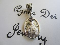 "Welcome to Agnus Dei Jewelry...\"iconic expressions of faith\"... For your consideration is a beautiful St. Teresa of Avila Holy Medal & Glass Crystal - 2Pc Pendant. Just attach to your necklace or European Style Bracelet! Perfect gift for a special mother, grandmother, godmother or a special friend...or just a beautiful gift for yourself! We took a brand new St. Teresa of Avila holy medal and attached a pretty Clear glass crystal charm in front, then attached them to a filigree bail. The r Silver Miraculous Medal For Wedding, Silver Miraculous Medal Jewelry For Wedding, Spiritual Wedding Miraculous Medal Jewelry, Silver Spiritual Jewelry For Baptism, Godmother Gifts Baptisms, St Teresa Of Avila, Catholic Confirmation, Teresa Of Avila, St Teresa