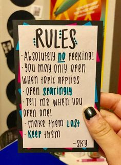 a person holding up a card that says rules