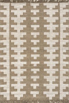 a brown and white striped rug with fringes