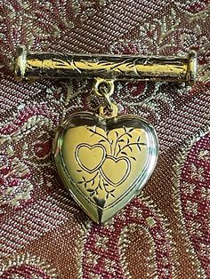 Sweet little Victorian styled gold tone heart locket that opens to put a picture of your loved one in it, or a lock of hair as they did in the victorian days. Locket pin measures 1 inch across its bar top and  about 1 1/4 in length. Good condition $18.00 Free shipping Victorian Gold Locket Brooches, Victorian Gold Brooch With Locket, Vintage Double Heart Locket Necklace, Gold Locket Brooch For Collectors, Gold Brooches With Vintage Charm For Gift, Gold Brooches With Vintage Charm As Gift, Vintage Locket Necklace For Valentine's Day Formal, Gold Locket Brooches For Gifts, Vintage Heart-shaped Brooch Jewelry