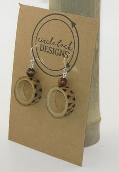 Bamboo earrings made from salvaged bamboo.  This pair features a design that has been burned on the outside of the bamboo ring. Additionally, this pair includes wood beads and silver hardware. The bamboo is sealed with Mod Podge and finished with clear, acrylic spray. Earthy Wooden Jewelry Gift, Earthy Wood Jewelry Gift, Earthy Wood Jewelry As Gift, Handmade Round Wooden Jewelry, Handmade Round Wooden Earrings, Handmade Wooden Round Earrings, Brown Wooden Beads Round Earrings, Brown Round Wooden Jewelry, Round Brown Wooden Jewelry