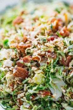 a salad with bacon, lettuce and other toppings