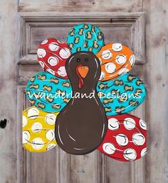 a turkey door hanger on a wooden door with polka doted eggs around it