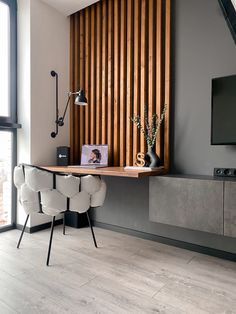 a living room with wooden slats on the wall