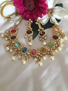 Adorn yourself with this gorgeous Jadau kundan Jewellery piece. You will definitely fall in love with the multicoloured Hydro Quartz stones. The statement Kundan earrings add to the charm of the beautiful royal necklace. Handcrafted by our skilled Indian craftsmen in brass with gold plating. The stunning premium quality collar necklace comes with a beautiful dori and is adjustable. Length of earrings: 8 cms, push back closure and a support clip at the back. One of our favourite picks for the wedding season ❤️ The necklace and earrings are the same as shown in the pictures. We have only one piece in this color and design, hence you get what you see in the pictures. Elegant Multicolor Kundan Necklace, Festive Multicolor Multi-stone Bridal Necklace, Multicolor Multi-stone Bridal Necklace For Festive Occasions, Multicolor Jeweled Kundan Necklace In Fusion Style, Multicolor Jeweled Kundan Fusion Necklace, Multicolor Multi-stone Kundan Necklace For Wedding, Elegant Multicolor Chandbali Kundan Necklace, Traditional Multicolor Multi-stone Jewelry Set, Festive Multicolor Fusion Bridal Necklace